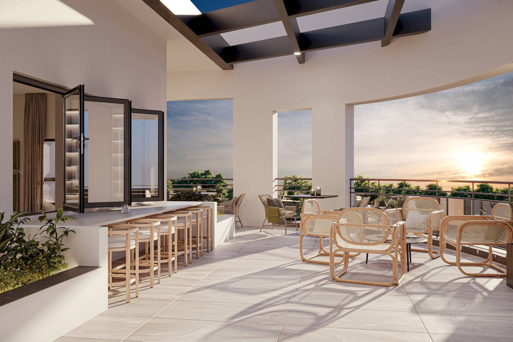 Modern outdoor terrace at sunset with bar seating, tables, wicker chairs, and potted plants.