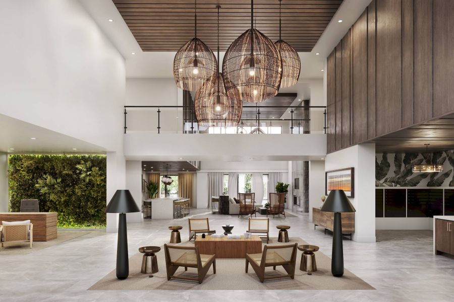 Modern hotel lobby with hanging lights, wooden furniture, and a green wall behind the reception desk.